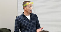 Teacher in class wearing visor