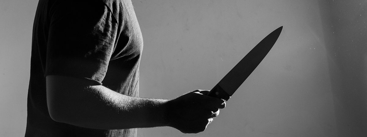 Neoliberalism 1200x450 - Man holding knife