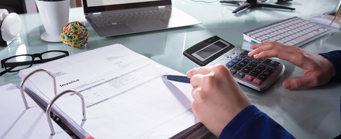 Student Quotes Accounting Generic 341x139 - Man using a calculator