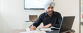 Executive MBA Image 341x139 - Man at a desk