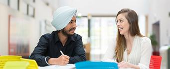 International Human Resources Images 341x139 - Man and woman sat at a desk