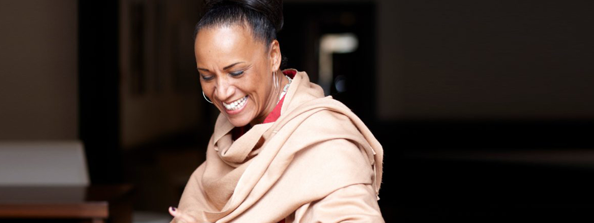 Lesley Lokko smiling while seated at a table