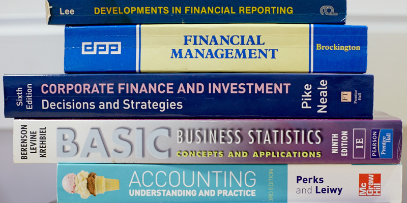 A neat pile of stacked Finance books