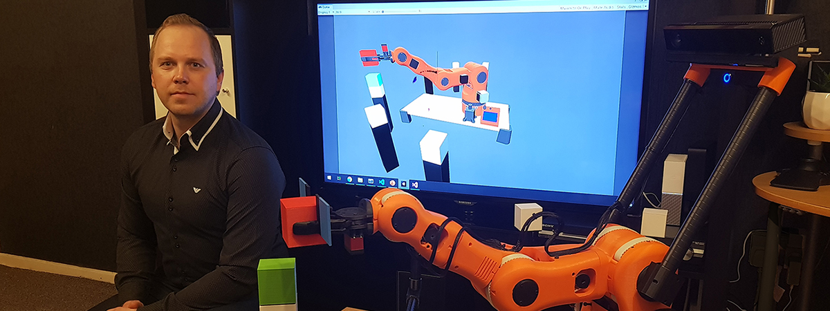 Marius sat next to his robotic arm