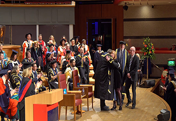Nichola Corner, sister of Lyra McKee, is hugged by Birmingham City University Vice Chancellor Philip Plowden on stage at Symphony Hall Birmingham. John Corner, Lyra McKee's brother-in-law, to the right.