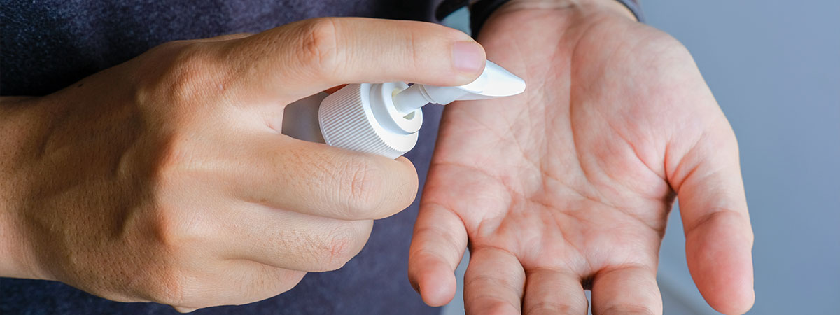 Person using hand sanitiser