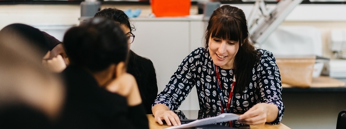 Trainee teacher working with pupils